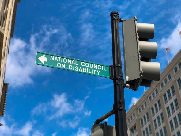 Downtown Washington, DC, street sign on a sunny day with a green NCD sign pointing to the left. 